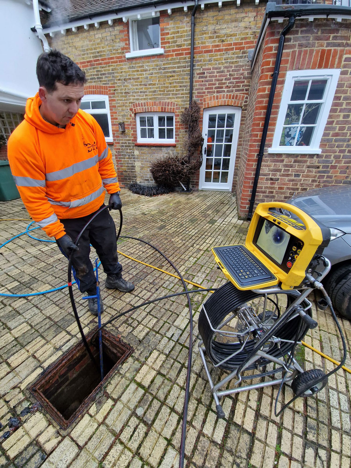 Declan from Drain Ace clearing a blocked drain in Guildford using CCTV inspection and high pressure drain jetting