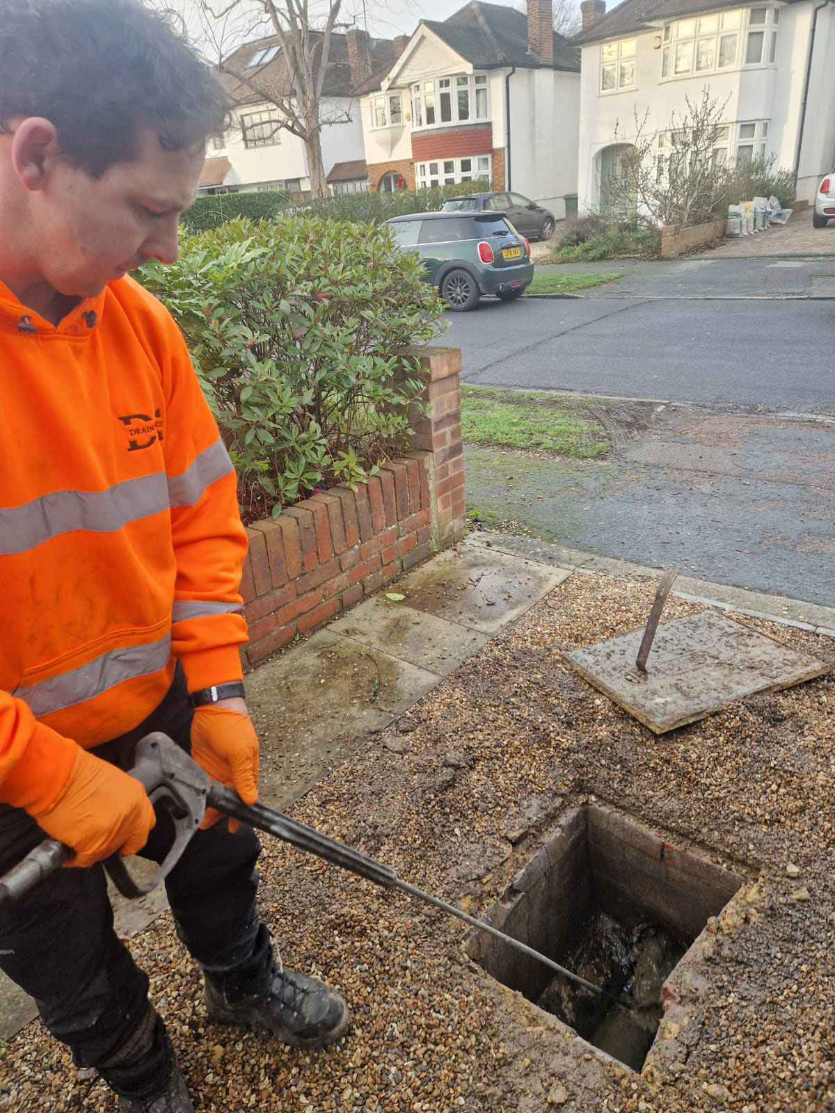 Declan from Drain Ace using a 2 metre drain jetting lance with turbo nozzle to unblock a drain in Epsom Surrey